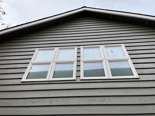 Side by side windows installed on second story of house