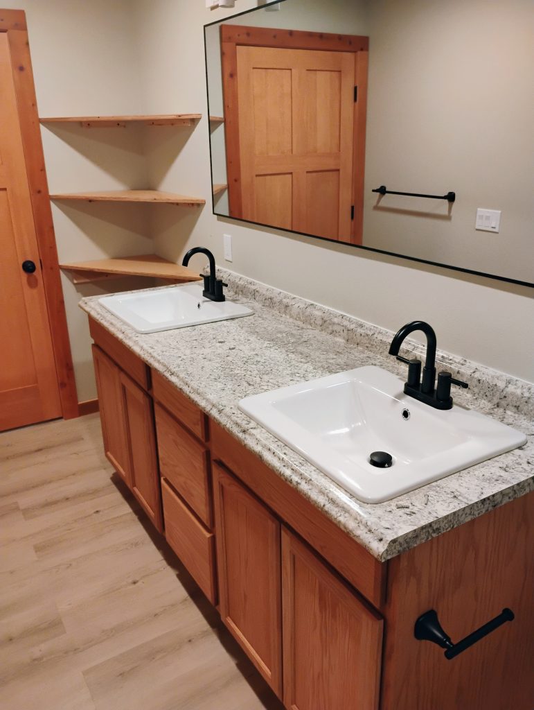 Brand new bathroom remodel with custom shelves, door, casing and cabinets all stained