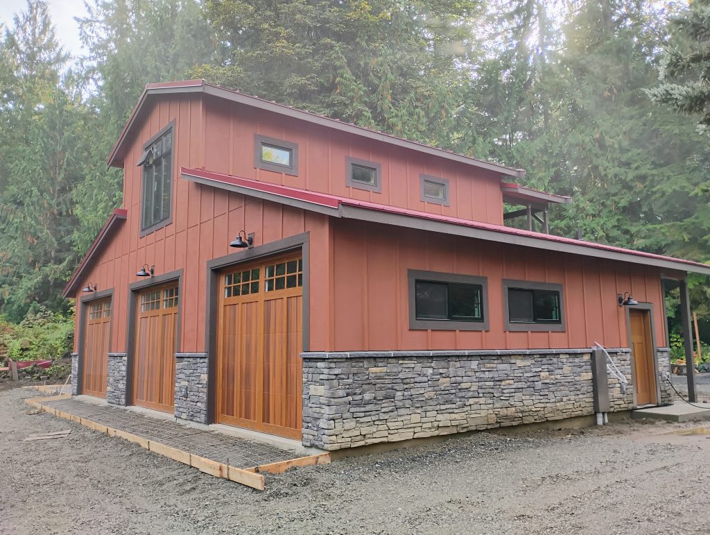 ADU in Snohomish, WA. Masonry Stone Veneer and Red Metal Roofing