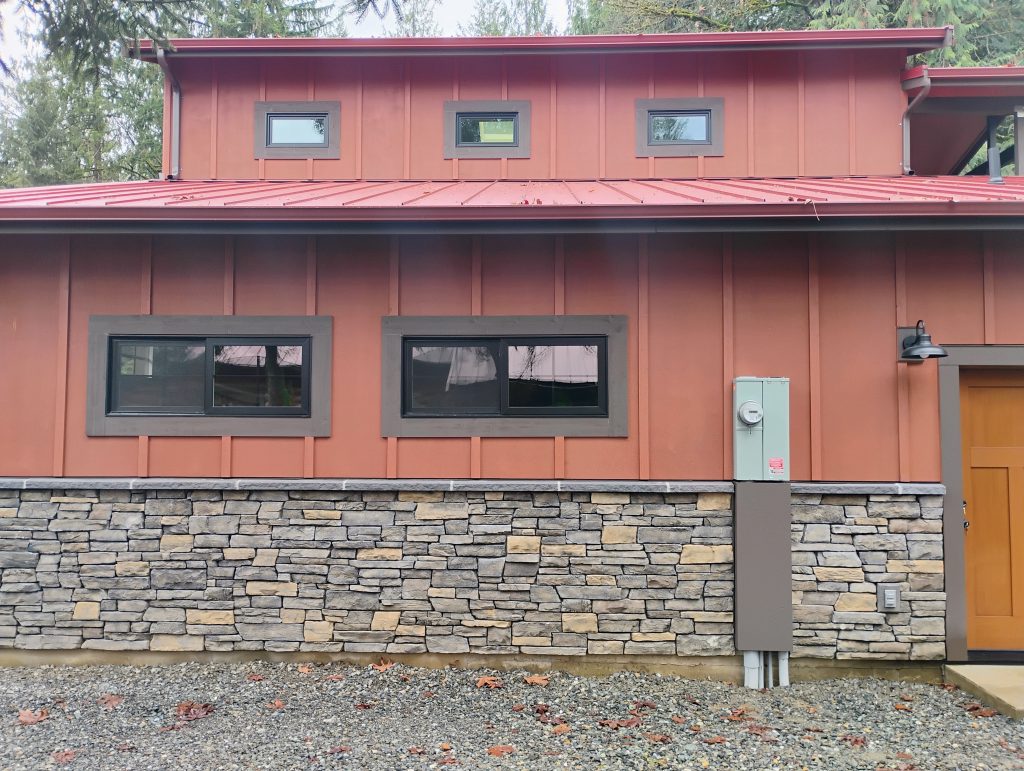 Side View of an ADU with Mason Stone Veneer, Siding and Metal Roofing