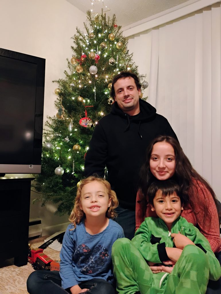 Matt McChesney and family photo in front of Christmas tree 2025